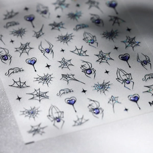 Holographic spider and web nail stickers with purple heart accents and metallic finish
