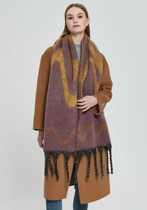 Close-up of thick scarf with purple and orange wave patterns and black fringe tassels