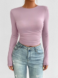 Detail of purple Y2K slim fit knitted long sleeve top with ruching and denim pants