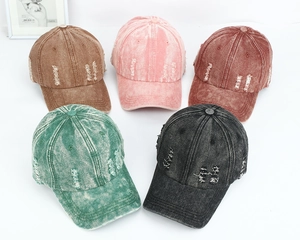 Various colors of distressed washed denim baseball caps with vintage ripped details