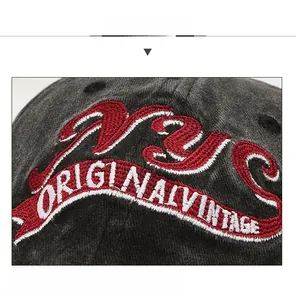 Detail of NYC 3D embroidery on washed vintage dark grey cotton baseball cap