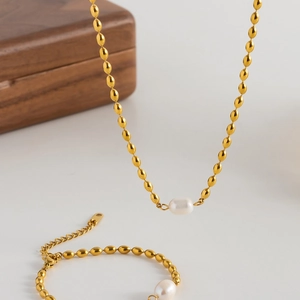 Elegant set of gold titanium steel rice bead chain jewelry with natural freshwater pearls