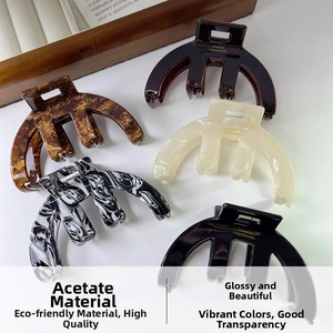 Detailed set of five acetate claw clips in tortoiseshell, marble, and pearl finishes