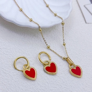 18K gold plated necklace and earring set with red heart pendants on shell background