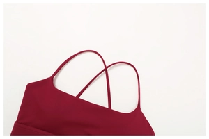 Close-up of wine red sports bra with criss-cross thin straps and square neckline detail