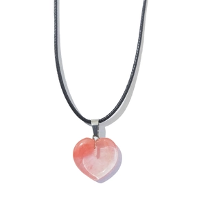 Pink heart-shaped crystal stone pendant with minimalist black cord necklace on white background