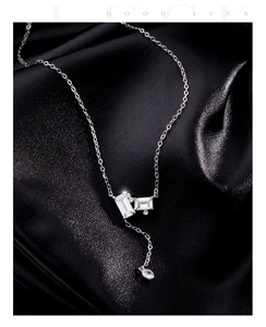 Macro detail of emerald-cut crystal pendant on sterling silver Y-shaped chain