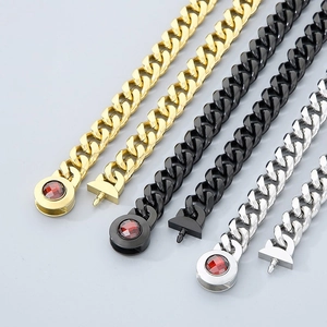 Detail of Cuban chain buckles in gold, black, and silver with red gems and magnetic clasps