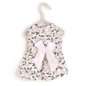 Pink lemon print pet dress with a satin bow displayed on a pearl hanger