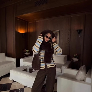 Retro ice cream color striped knit cardigan with brown trousers and a winter tote bag