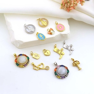 Detail view of various gold and silver hip-hop charms featuring religious and animal motifs