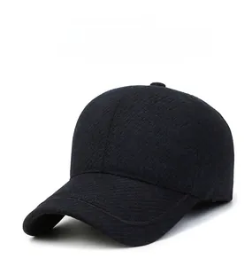 Detail of winter baseball cap showing thick textured fabric and silver metal letter M