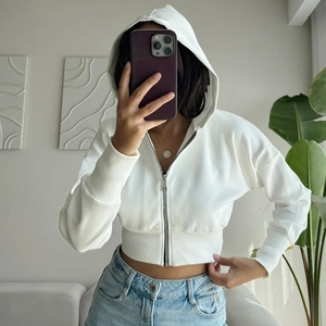 Women's white cropped zip-up hoodie with drawstring hood and ribbed cuffs for casual wear