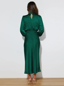 Detail of the open-back cutout and high neck on a dark green satin midi dress