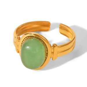 Detail of 18K gold plated stainless steel ring with oval green gemstone centerpiece