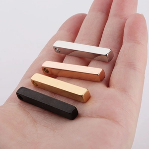 Detailed close-up of 3D bar pendants in silver, gold, rose gold and black stainless steel