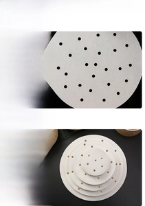Macro detail of breathable perforated round steamer paper liners in multiple sizes