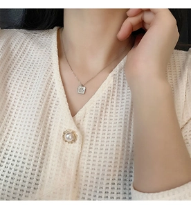 Close-up of a square shell smiley face pendant on a titanium steel necklace chain