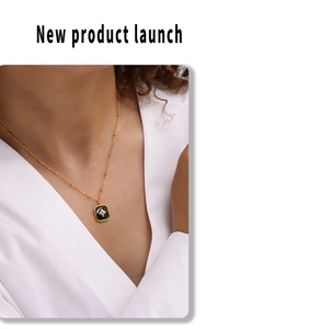 Detail of vintage black square pendant with star zircon on a gold beaded chain