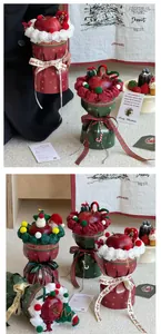 Close-up of Christmas apple gift box with festive packaging and plush snowman decor