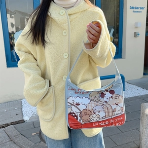 Close-up of light blue canvas tote bag with cartoon puppy illustration and shoulder strap