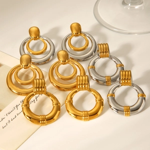 Close-up of retro mixed metal hoop earrings with textured gold and silver finish