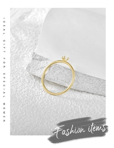 Detailed view of gold plated minimalist ring with a four-prong set sparkling zircon stone