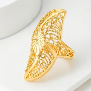 Golden Dubai bridal ring with intricate filigree hollow pattern and ethnic sunburst motif