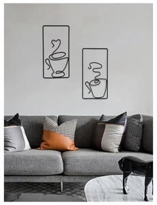 Minimalist black metal wire coffee cup wall art hanging in a modern living room