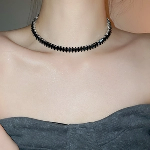 Close-up of black marquise-cut zircon stones on a silver-plated minimalist choker