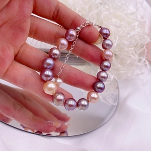 Close-up of purple and champagne freshwater pearl bracelet with adjustable silver clasp