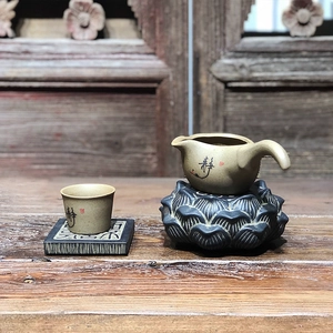 Close-up of Zen style ceramic tea set with calligraphy on textured wooden background