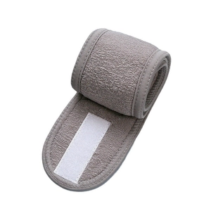 Detail of adjustable gray spa headband with strong velcro closure and soft fabric texture