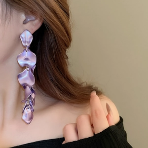 Close-up of long purple petal tassel earrings with matte finish and layered 3D design