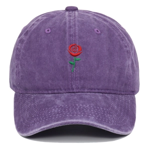 Close-up of red rose embroidery on purple washed cotton vintage baseball cap fabric