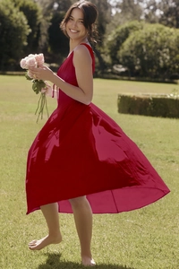 Detail of flowy red V-neck maxi dress with floral print moving in the summer breeze