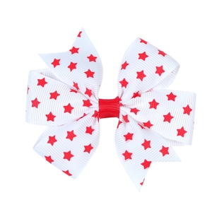 Detail of double-layer bow hair clip with red stars pattern on white ribbed ribbon
