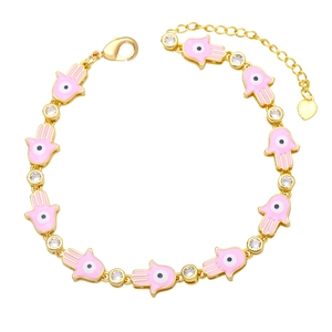 Detail of pink enamel Hamsa hand bracelet with evil eye charms and golden finish