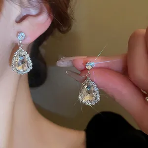 Elegant silver teardrop rhinestone earrings with large crystal pendants for formal wear