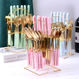 24-piece golden stainless steel cutlery set with marble texture handles and metal rack