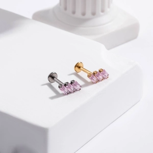 Detailansicht goldener und silberner Labret-Stecker mit rosa Zirkonia-Steinen