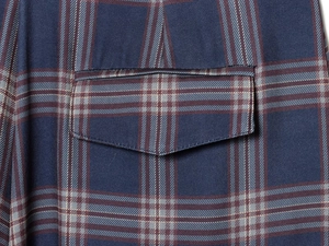 Detailed close-up showing the cargo pocket stitch and navy plaid fabric pattern