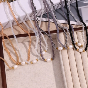 Close-up of beaded necklaces featuring freshwater pearls and colorful crystal beads