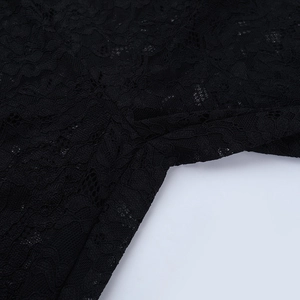 Close-up of the intricate floral lace stitching and seamless finish on the black bodysuit