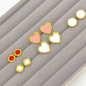 Vintage style pearl tassel earrings collection in heart and round shapes on velvet display