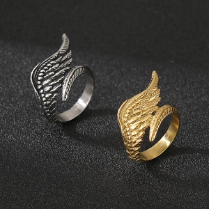 Macro shot of stainless steel angel wing rings with detailed feather textures