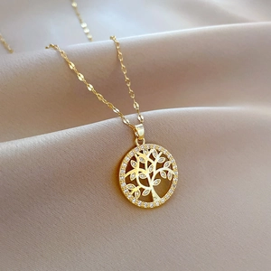 Elegant gold Tree of Life pendant necklace with pavé zircons on beige silk fabric