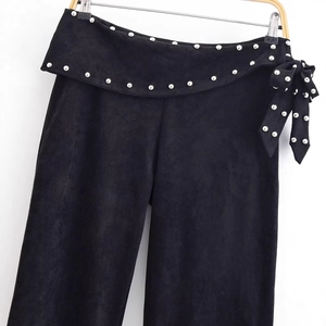 Women's black faux suede flared trousers with silver studs and bow detailing