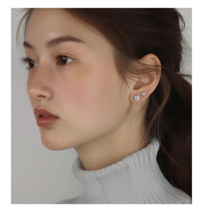 Close-up of elegant S925 silver stud earrings with sparkling round zirconia on a model