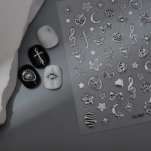 Detail of silver 3D star and moon Y2K nail stickers with metallic finish on nails